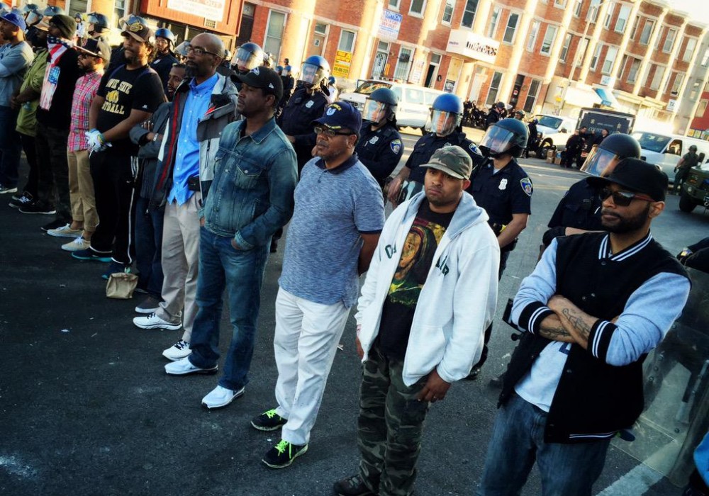 men-standing-police-line-baltimore